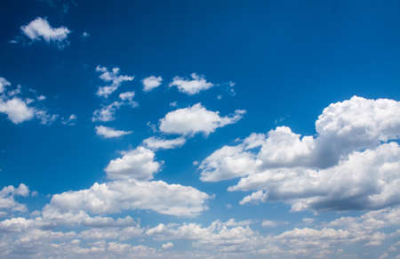 Bright clouds in the blue summer skyの写真素材