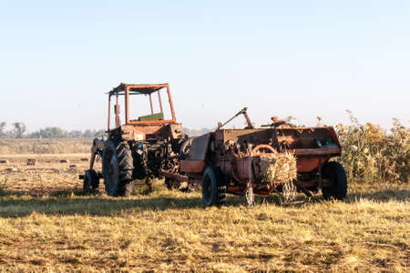 Old tractor standing on the fieldの写真素材