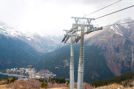 Ski lift in the mountains of the Northern Caucasus in the autumn foggy weatherの写真素材