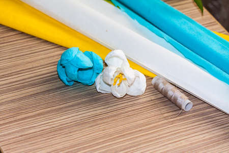 Homemade flowers of colored corrugated paper corrugated paper lie on the surface of the tableの写真素材