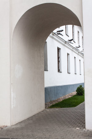 The passage in the form of an arch in the wall of the old city Minsk Belarusの写真素材