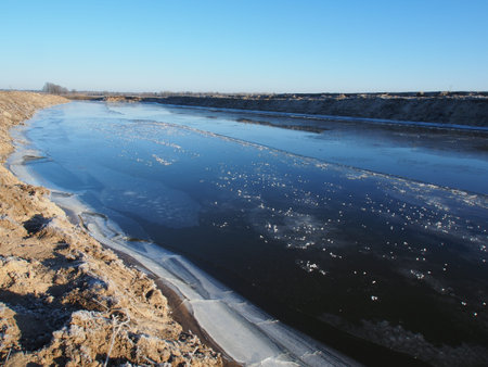 Ice cover is forming on a surface of a small river