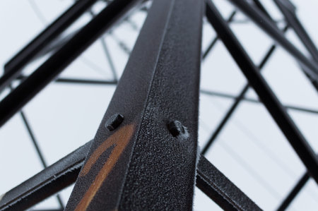 Closeup atmospheric photo of the high voltage transmission tower covered with hoarfrost standing on...