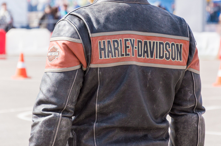 MINSK, BELARUS - APRIL 24, 2016 HOG. Harley Owners Group opening driving season show. Close-up view of the man in genuine leather jacket with Harley Davidson.のeditorial素材