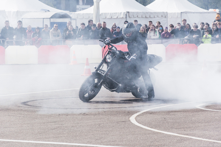 MINSK, BELARUS - APRIL 24, 2016 HOG. Harley Owners Group opening driving season show. Professional rider drifting with brand new black Harley Davidson motorbike. Stunt ride show.のeditorial素材