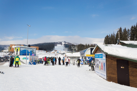 BUKOVEL, UKRAINE - FEBRUARY 28, 2018 Tourists standing in the line to the chairliftのeditorial素材