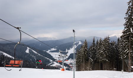 BUKOVEL, UKRAINE - FEBRUARY 28, 2018 Panoramic view of the ski slope, chairlift and mountains in Bukovel, Ukraineのeditorial素材