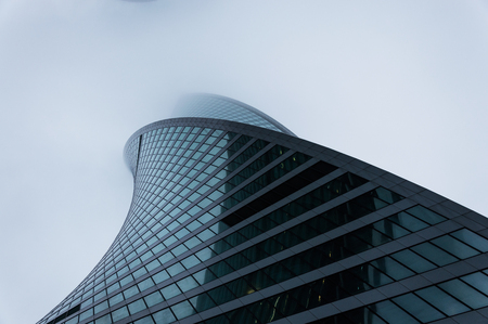 Facade of the modern skyscraper in the fogのeditorial素材