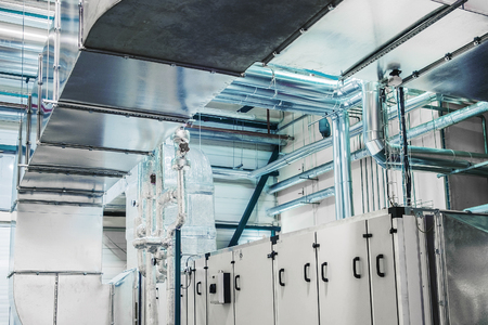Side view of the huge industrial air handling unit in the ventilation plant roomの写真素材