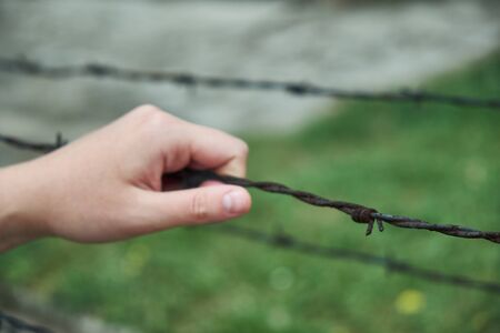 fence, tower, barbed wire, barracks, arm, touchingの写真素材