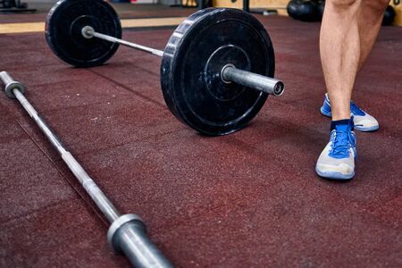Barbel on the floor in the crossfit box. Concept of the crossfit training, online qualifiers for the crossfit championships.の写真素材