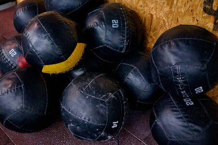 Pile of crossfit wall balls near to the wall. The balls are using for the wall-ball exercise.の写真素材