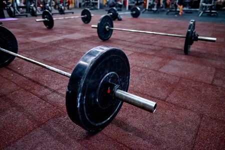 Barbel on the floor in the crossfit box. Concept of the crossfit training, online qualifiers for the crossfit championships.の写真素材