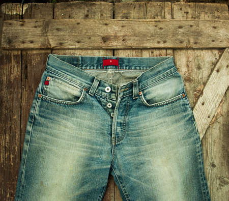 Old jeans on a wooden backgroundの写真素材