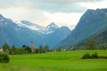 Norwegian Church amid grand mountainsの写真素材