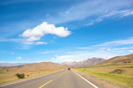 Acceleration lane leading straight to a mountains rangeの写真素材