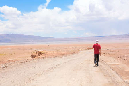 Man hitchhiking the car on deserted road, Boliviaの写真素材
