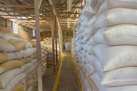 Stack of bags with coffee beans at warehouseの写真素材