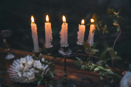 Vintage candelabra with burning candles on background wooden tableの写真素材