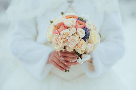 bride with a bouquet on the winter backgroundの写真素材