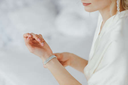 the bride wears a bracelet on handの写真素材