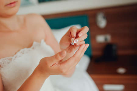 Bride wears earrings preparing for the weddingの写真素材