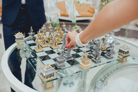 Bride with the groom playing chess at a weddingの写真素材
