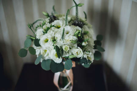 beautiful bridal bouquet lying on the tableの写真素材