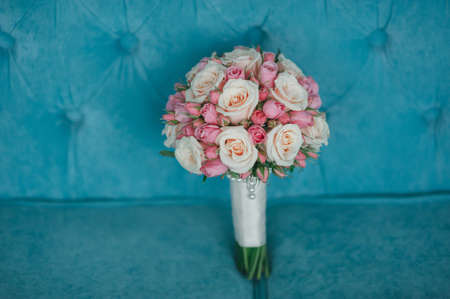 pink bridal bouquet with ribbons on the bedの写真素材