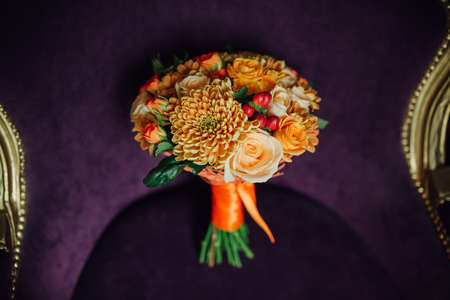 bridal bouquet of roses lying on the sofaの写真素材