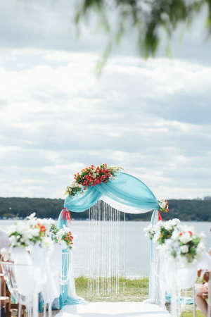 Wedding Arch of turquoise color on the background lakeの写真素材
