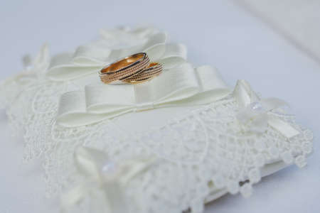 gold wedding rings on a light backgroundの写真素材