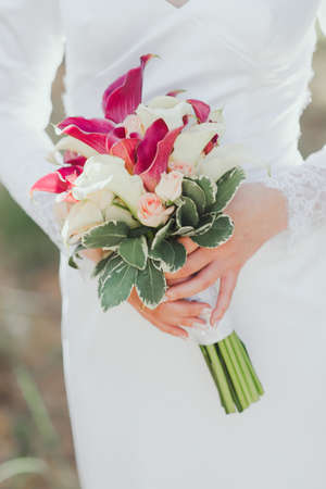 bridal bouquet in hands of the brideの写真素材