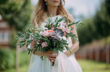 bridal bouquet in hands of the brideの写真素材