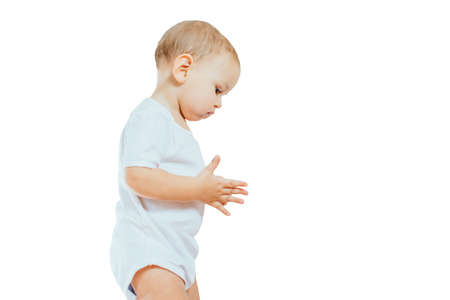 sad child in a white body suit standing on background, isolatedの写真素材