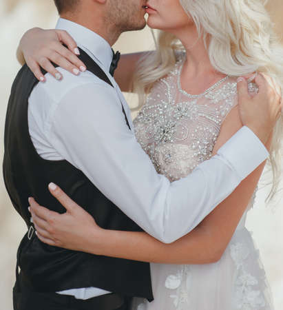 bride and groom embracing in mountains hdの写真素材