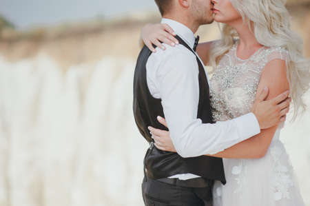 bride and groom embracing in mountains hdの写真素材