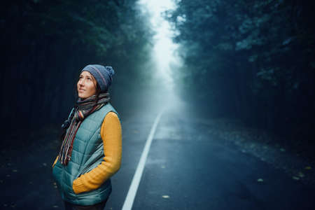 girl tourist on background of a winter roadの写真素材