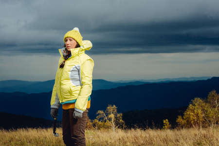 girl tourist on background of mountain sceneryの写真素材