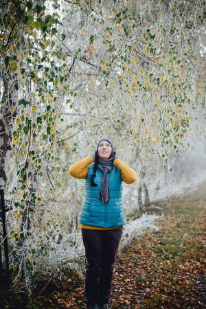 girl tourist on background of beautiful frozen tree. Winter landscapeの写真素材
