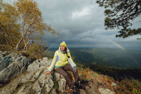 Woman traveler on a rainbow backgroundの写真素材