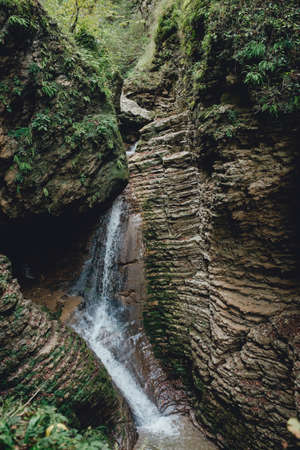 Waterfall. The mountain river between the rocksの写真素材
