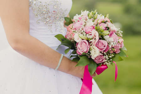 bridal bouquet in hands of the brideの写真素材