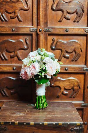 Beautiful bridal bouquet on the wooden backgroundの写真素材
