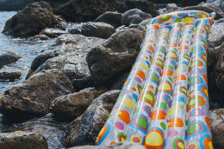 Air mattress on the rocks by the sea. The concept of vacationの写真素材
