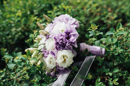 beautiful bridal bouquet of blue flowers on a green backgroundの写真素材