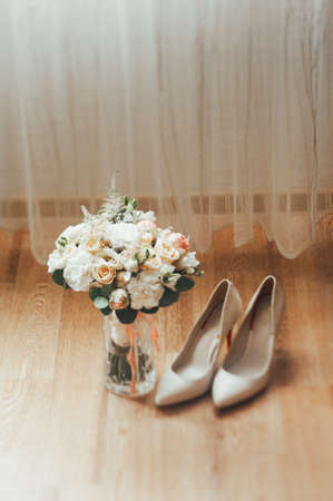 bridal bouquet of white flowers. brides shoesの写真素材