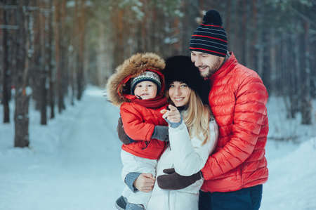 young family with child on the winter backgroundの写真素材