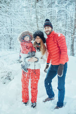 young family with child on the winter backgroundの写真素材