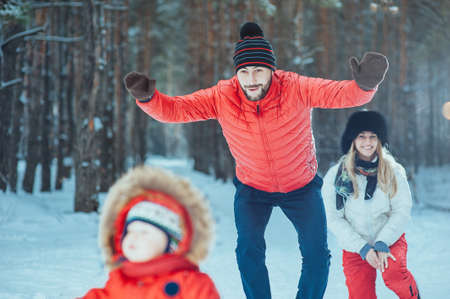 young family with child on the winter backgroundの写真素材